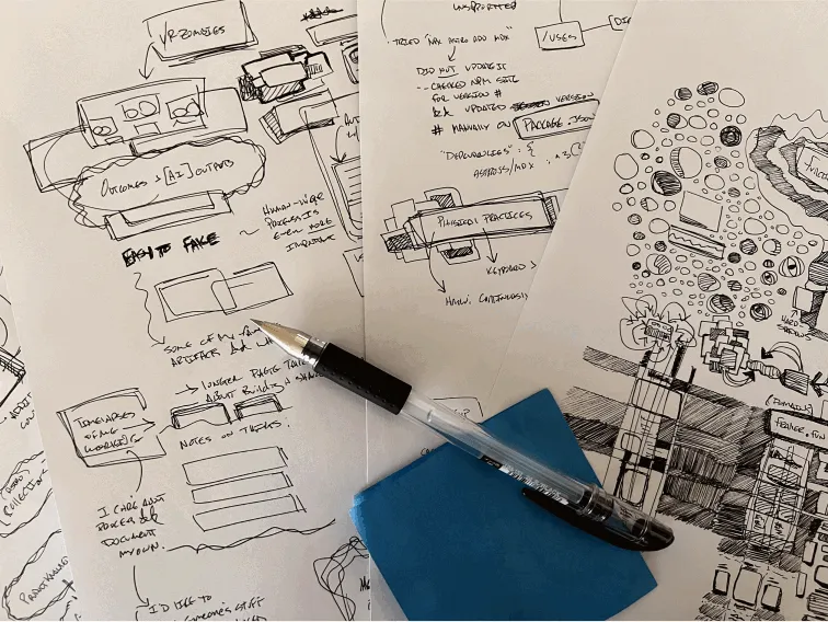 Close-up of hand-drawn sketches and layout ideas on paper, with a black pen, illustrating the brainstorming process of a creative project, created by Kelsy Gagnebin